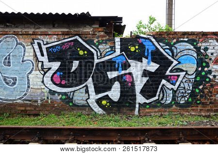 Full And Acomplished Graffiti Artwork. The Old Wall Decorated With Paint Stains In The Style Of Stre