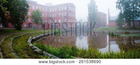 Forssa Finland, The Old Spinning Mill Of Red Brick On A Foggy Day And Loimijoki River