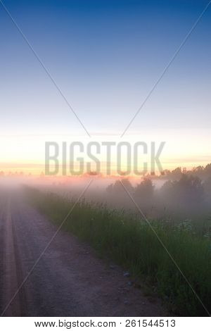Beautiful Morning Sunrise Landscape. Scenic Countryside Landscape Under A Colorful Sky At Sunset Daw