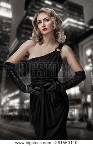 Retro Portrait Of Inaccessible Beautiful Woman In Black Dress With Red Lips, Smokey Eyes And Long Ea