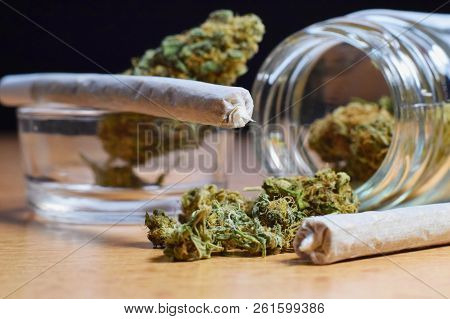 Marijuana Buds, Jar, Money And Joints On The Table