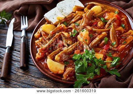 Greek Okra Stew With Potato Served With Feta Cheese Slices On A Earthenware Plate On A Rustic Table,