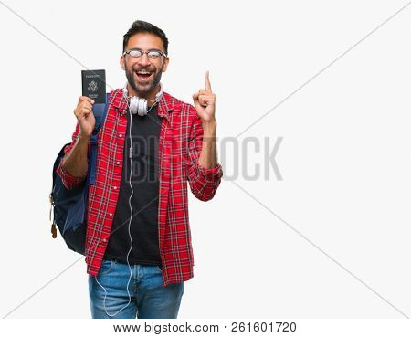 Adult hispanic student man holding passport of america over isolated background surprised with an idea or question pointing finger with happy face, number one