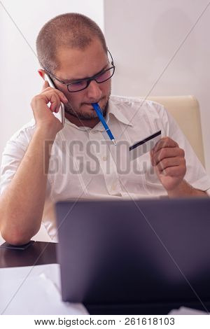 Successful Male Owner Of Business Company Talking With Operator While Making Banking Online Consulti