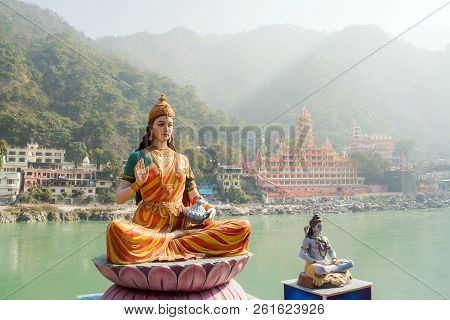 Statue Of Sitting Goddess Parvati And Statue Shiva On The Riverbank Of Ganga In Rishikesh.