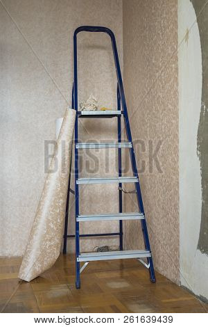 Folding Staircase And Roll Of Wallpaper Before Sticking In The Room