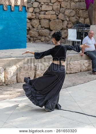 Jerusalem, Israel, September 29, 2018 : Dancer In A Black Authentic Dress Dances To The Music For Vi