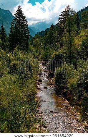 A Small River Flowing Through The Vilalge Of Steg In Central Liechtenstein