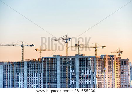 Construction Site With Buildind Cranes At Sunset