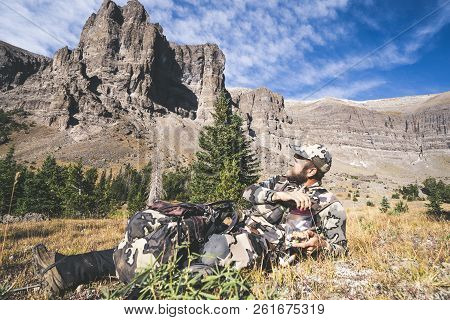September 16 2018 - Dubois, Wyoming: Elk Hunter Taking A Break, Eating Trail Mix In A Bag, With View