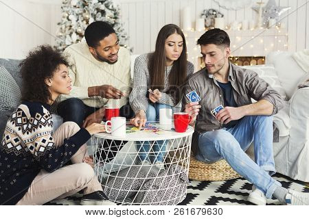 Christmas Holidays With Close Friends. Multiethnic Company Playing Card Game, Copy Space