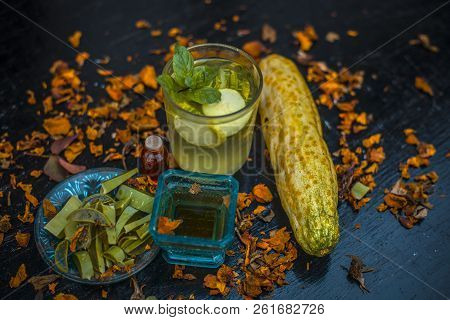 Close Up Of Organic Face Pack Of Cucumber With Aloe Vera Gel And Rose Oil On Wooden Surface In A Gla