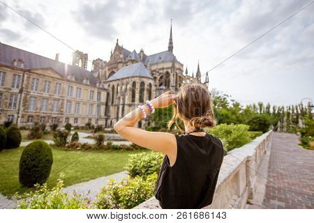 Young Woman Enjoying Beautiful View On The Reims Cathedral And Gardens Traveling In Reims City, Fran