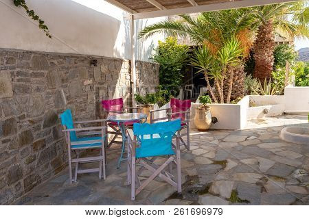 Serifos, Greece - September 8, 2018: Colorful Chairs In The Garden Patio. Serifos Island. Greece