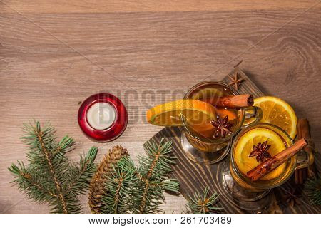 Two Glasses With Delicious Fragrant Tea Of Mulled Wine With Orange And Spices On A Wooden Board With