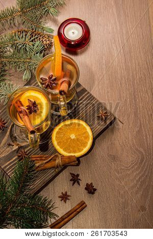 Two Glasses With Delicious Fragrant Tea Of Mulled Wine With Orange And Spices On A Wooden Board With