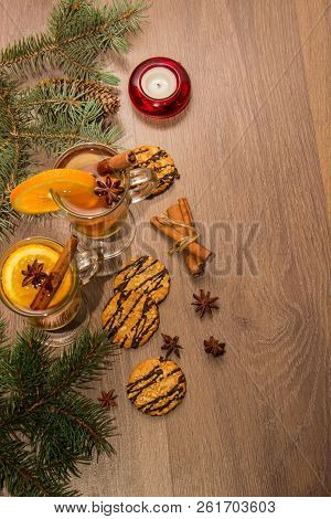 Two Glasses With Delicious Fragrant Tea Of Mulled Wine With Orange And Spices On A Wooden Board With