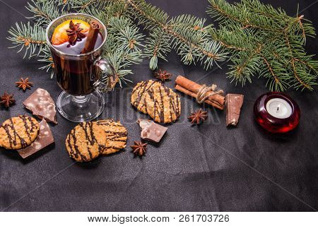 A Glass Of Flavored Mulled Wine On A Black Leather Background With Biscuits Pieces Of Chocolate Chop