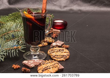 A Glass Of Flavored Mulled Wine On A Black Leather Background With Biscuits Pieces Of Chocolate Chop