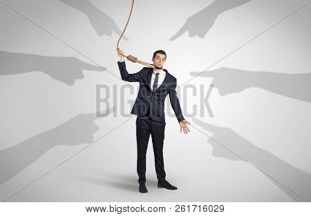 Young businessman trying to suicide with pointing hands concept