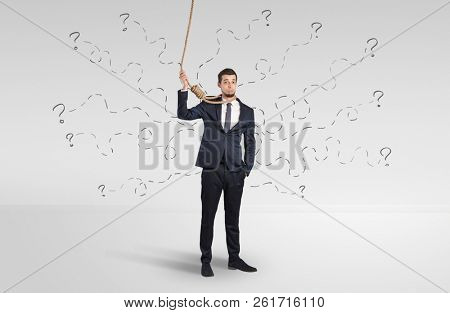 Hopeless young businessman trying to suicide with question signs concept