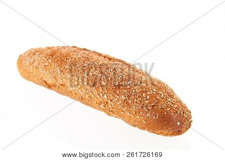 Brown multigrain bread with knife on cutting board isolated over white background
