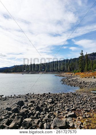 Foliage In Vibrant Fall Colors Of Red And Yellow Along The Shores Of Elk Lake In The Cacade Mountain