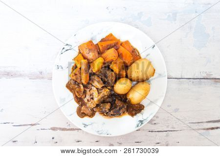 Beef meat stewed with potatoes-Traditional French cuisine Beef Bourguignon potatoes carrots in persillade