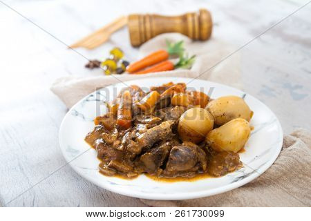Beef meat stewed with potatoes-Traditional French cuisine Beef Bourguignon potatoes carrots in persillade