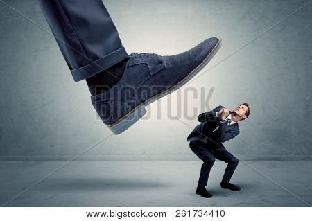 Demoralised employee symbolized by small man getting trampled