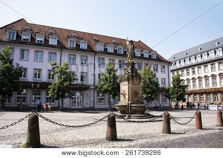 German And Foreigner Travelers People Walking And Visit Madonna Statue At The Corn Market Square Or 