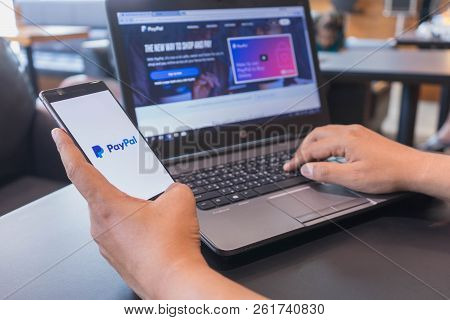 Chiang Mai, Thailand - Mar 18,2018: Man Holding Huawei With Paypal Apps On Screen. Paypal Is An Onli