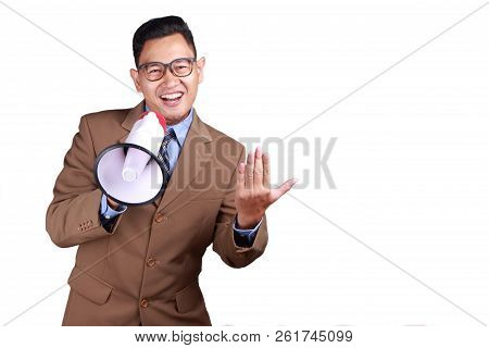 Young Asian Businessman Wearing Suit Using Megaphone, Promoting Gesture. Close Up Body Portrait. Iso