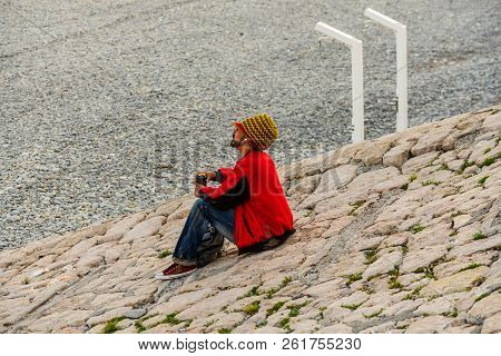 Nice, France - 2018.
Rasta Man In Red On The Pebble Beach From Nice, French Riviera.