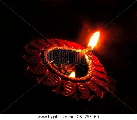 Close Up Isolated Low Key Dipavali Or Diwali Oil Clay Lamp, Chirag Or Panti Shot With A Dutch Angle 