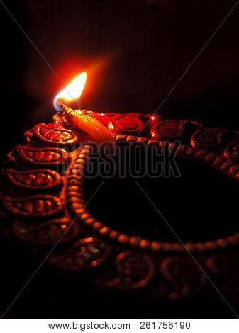 Close Up Isolated Low Key Indian Dipavali Oil Clay Lamp, Chirag Or Panti, Shot From Side Top Down An