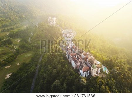Aerial View Of French Style Building At Bukit Tinggi With Dramatic Fog And Sunrise.