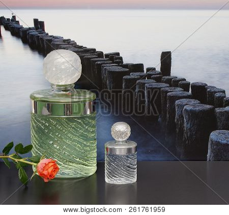 Fragrance For Ladies, Large Perfume Bottle Next To A Commercial Perfume Bottle In Front Of The Pictu