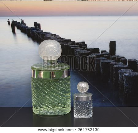 Fragrance For Ladies, Large Perfume Bottle Next To A Commercial Perfume Bottle In Front Of The Pictu