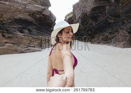 Woman Holding Her Couple Hand Into The Shite Beach