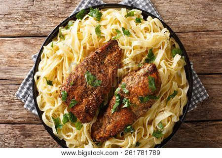 American Fried Chicken Breast Lazone With Fettuccine Pasta In A Creamy Sauce Closeup On A Plate. Hor