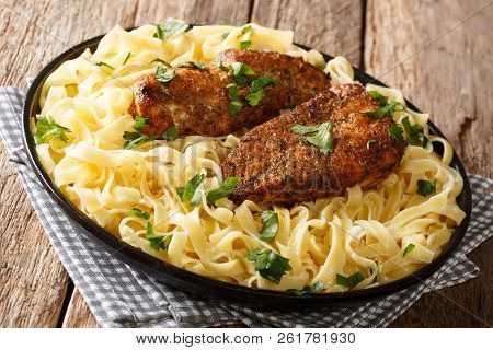 American Fried Chicken Breast Lazone With Fettuccine Pasta In A Creamy Sauce Closeup On A Plate. Hor