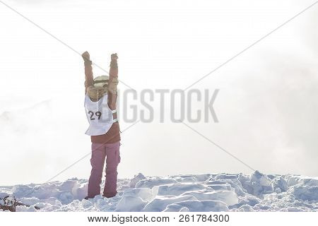 Portrait Of A Snowboarder Woman Freerider In Helmet In Snowy Mountains