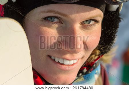 Portrait Of A Snowboarder Woman Freerider In Helmet In Snowy Mountains