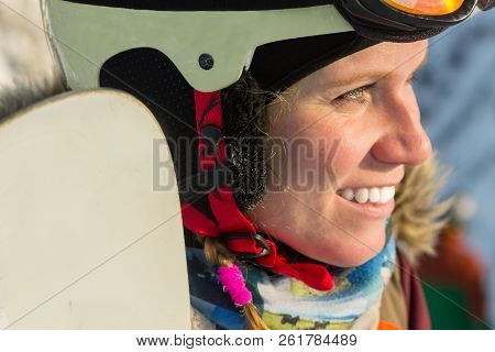Portrait Of A Snowboarder Woman Freerider In Helmet In Snowy Mountains