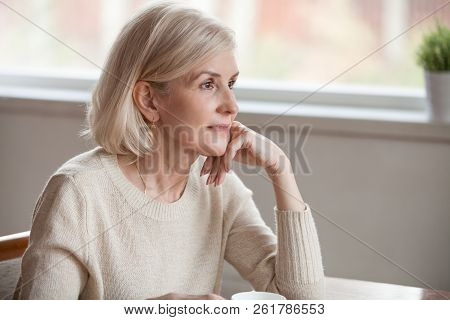 Thoughtful Middle Aged Beautiful Woman Looking Away Drinking Cof