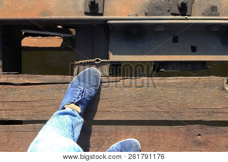 Men's Feet On The Railway Bridge