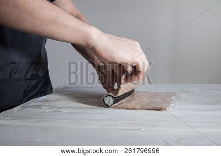 Process Of Making Maki Sushi. Cook Chef Hands Preparing Rolls With Cheese, Avocado And Sesame Seeds 