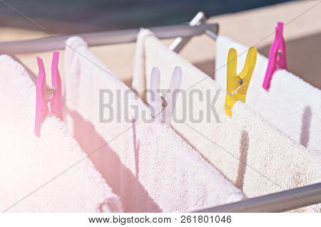 Fresh Clean Towels Drying On Washing Line Outdoor. Laundry Hangs On The Dryer. Drying Clean Clothes 