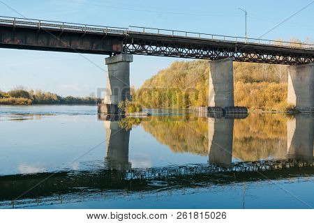 Old Bridge Over The River. Autumn Landscape With A Bridge